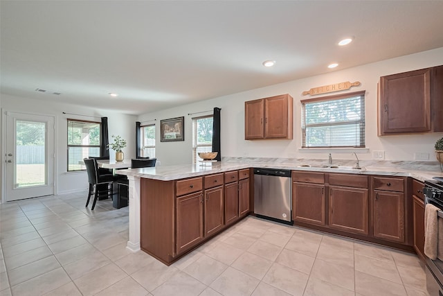 766 Hardwood Grove Ct, Houston, TX 77090 - kitchen featuring stainless steel dishwasher, a sink, a peninsula, healthy amount of natural light, and recessed lighting