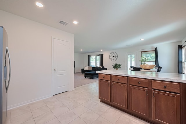 766 Hardwood Grove Ct, Houston, TX 77090 - kitchen with stainless steel fridge, light countertops, recessed lighting, light tile patterned floors, and open floor plan