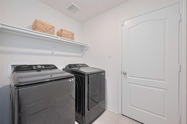 766 Hardwood Grove Ct, Houston, TX 77090 - laundry room featuring washing machine and clothes dryer, light tile patterned floors, and baseboards