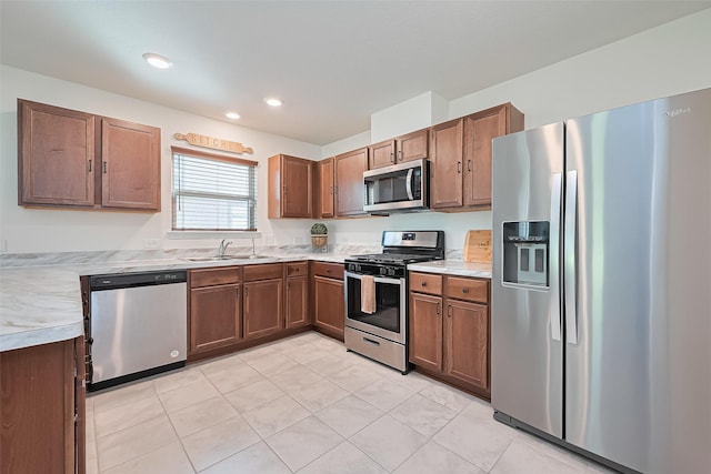 766 Hardwood Grove Ct, Houston, TX 77090 - kitchen featuring stainless steel appliances, light countertops, a sink, light tile patterned floors, and recessed lighting