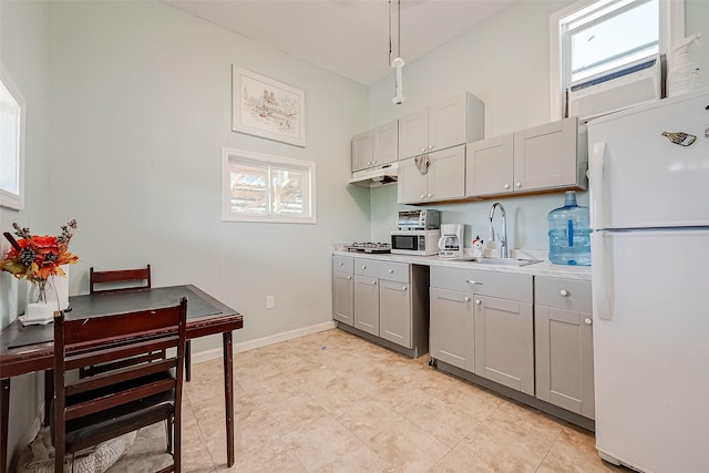 2087 Rd 5210, Cleveland, TX 77327 - kitchen featuring freestanding refrigerator, a sink, gray cabinetry, and healthy amount of natural light