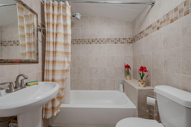 2087 Rd 5210, Cleveland, TX 77327 - bathroom featuring tile walls, shower / bath combo, toilet, a textured ceiling, and a sink