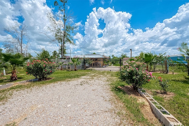 2087 Rd 5210, Cleveland, TX 77327 - view of dirt / gravel driveway with a gate and a gated entry