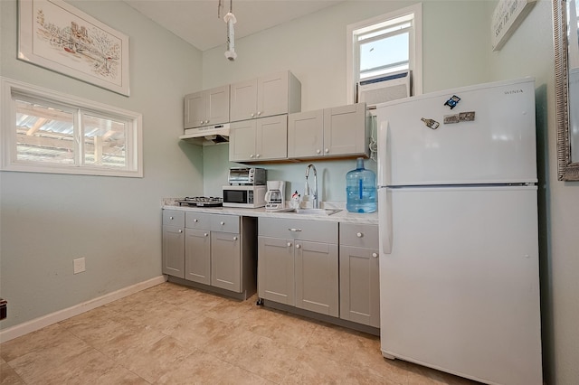 2087 Rd 5210, Cleveland, TX 77327 - kitchen featuring freestanding refrigerator, gray cabinets, a sink, and healthy amount of natural light