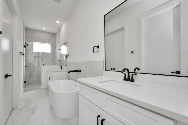 853 Mansfield St Unit F, Houston, TX 77091 - full bath with a marble finish shower, two vanities, marble look tiles, a soaking tub, and recessed lighting