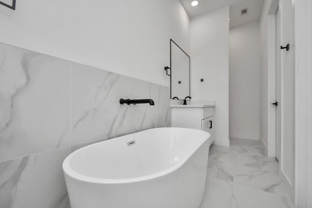 853 Mansfield St Unit F, Houston, TX 77091 - bathroom with marble finish flooring, a soaking tub, vanity, and recessed lighting