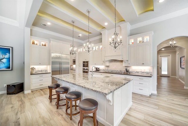 22414 Meadowhurst Cir W, Tomball, TX 77377 - kitchen with stainless steel appliances, a large island with sink, decorative backsplash, beam ceiling, and white cabinets