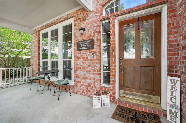 9103 Huckinston Ct, Spring, TX 77379 - view of exterior entry featuring brick siding and covered porch