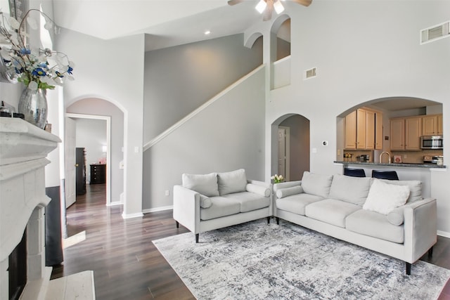 9103 Huckinston Ct, Spring, TX 77379 - living area featuring a high ceiling, ceiling fan, dark wood finished floors, baseboards, and recessed lighting