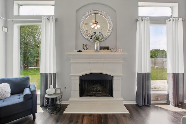9103 Huckinston Ct, Spring, TX 77379 - living area featuring dark wood finished floors and a fireplace with raised hearth