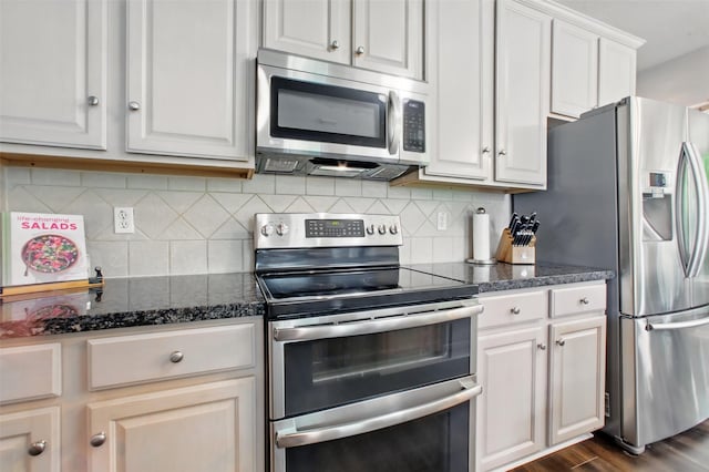 9103 Huckinston Ct, Spring, TX 77379 - kitchen with stainless steel appliances, white cabinets, backsplash, and dark wood finished floors