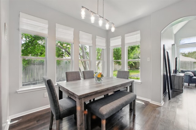 9103 Huckinston Ct, Spring, TX 77379 - dining room with baseboards, arched walkways, and dark wood-style flooring
