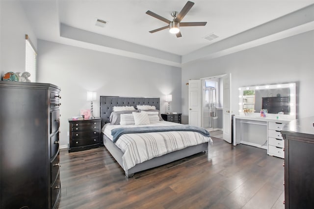 9103 Huckinston Ct, Spring, TX 77379 - bedroom featuring a raised ceiling, dark wood finished floors, ceiling fan, and ensuite bath