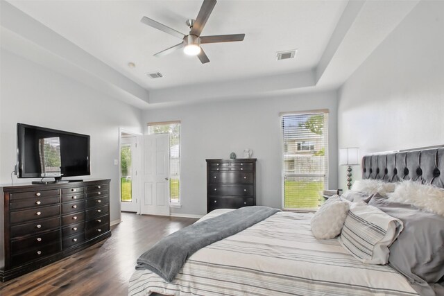 9103 Huckinston Ct, Spring, TX 77379 - bedroom with dark wood-type flooring, a raised ceiling, baseboards, and ceiling fan
