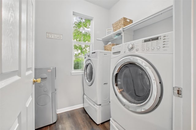 9103 Huckinston Ct, Spring, TX 77379 - laundry room with separate washer and dryer, dark wood-style flooring, and baseboards