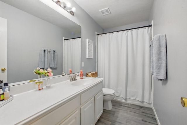 9103 Huckinston Ct, Spring, TX 77379 - full bathroom featuring vanity, toilet, and wood finished floors