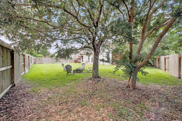 9103 Huckinston Ct, Spring, TX 77379 - view of yard with an outdoor fire pit