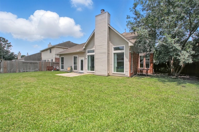 9103 Huckinston Ct, Spring, TX 77379 - rear view of house with a chimney and a patio area