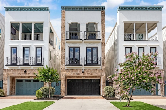619 W 26th St, Houston, TX 77008 - multi unit property featuring an attached garage, concrete driveway, stucco siding, a balcony, and brick siding
