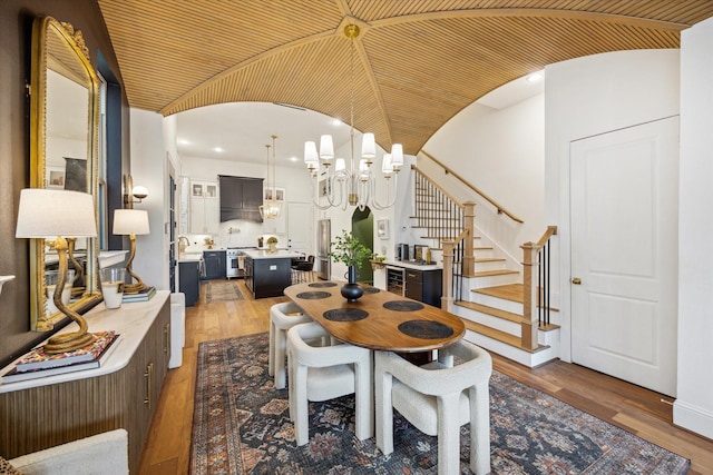 619 W 26th St, Houston, TX 77008 - dining room with a chandelier, stairs, wood finished floors, vaulted ceiling, and recessed lighting