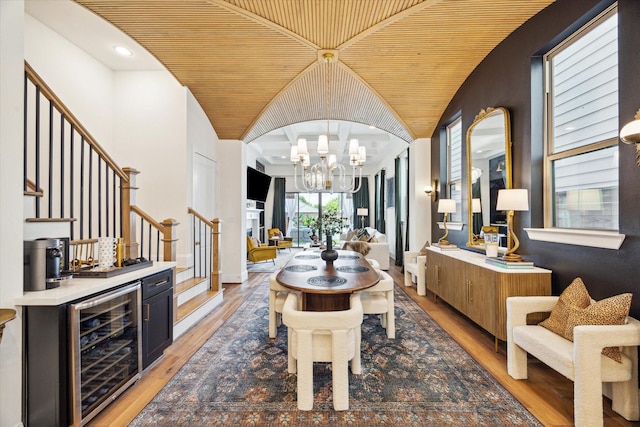 619 W 26th St, Houston, TX 77008 - dining space featuring beverage cooler, wood ceiling, stairs, a chandelier, and vaulted ceiling