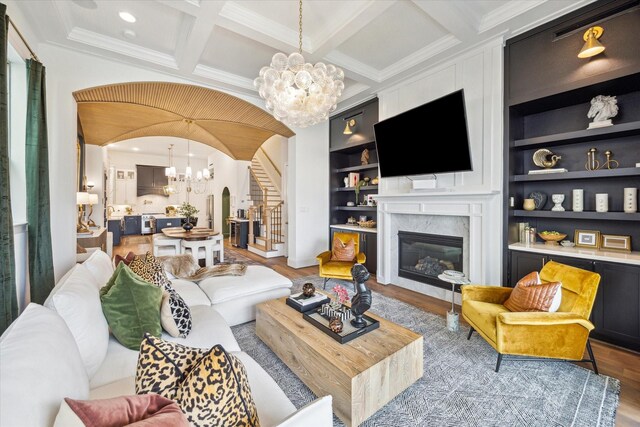 619 W 26th St, Houston, TX 77008 - living area featuring a chandelier, arched walkways, wood finished floors, a fireplace, and beamed ceiling