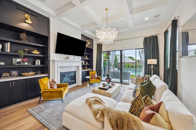 619 W 26th St, Houston, TX 77008 - living area featuring light wood-style floors, beamed ceiling, coffered ceiling, a chandelier, and a glass covered fireplace