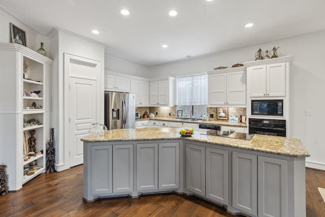 13614 Champions Centre Dr, Houston, TX 77069 - kitchen featuring black appliances, a spacious island, white cabinets, tasteful backsplash, and dark wood finished floors