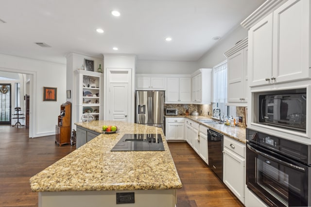 13614 Champions Centre Dr, Houston, TX 77069 - kitchen featuring black appliances, a kitchen island, white cabinets, recessed lighting, and tasteful backsplash
