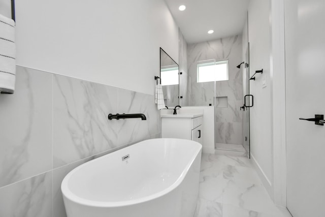 849 Mansfield St Unit B, Houston, TX 77091 - full bathroom featuring marble look tiles, a marble finish shower, a soaking tub, vanity, and recessed lighting