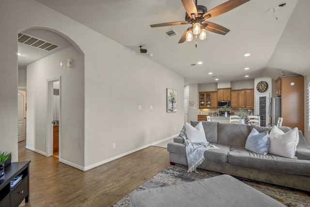 9210 Monarch Field Ln, Cypress, TX 77433 - living area featuring a ceiling fan, wood finished floors, recessed lighting, vaulted ceiling, and arched walkways