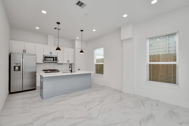 853 Mansfield St Unit C, Houston, TX 77091 - kitchen with appliances with stainless steel finishes, light marble finish floors, white cabinets, backsplash, and recessed lighting
