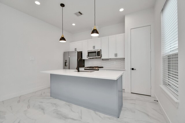 853 Mansfield St Unit C, Houston, TX 77091 - kitchen with stainless steel appliances, light marble finish flooring, a kitchen island with sink, tasteful backsplash, and recessed lighting