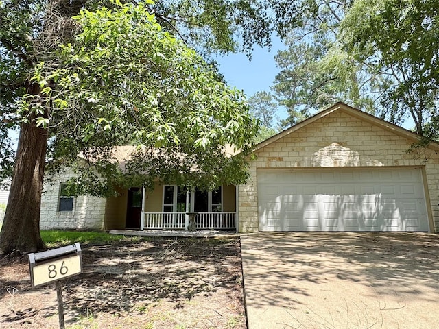 86 Huntington, Trinity, TX 75862 - view of front of property featuring driveway, covered porch, and an attached garage