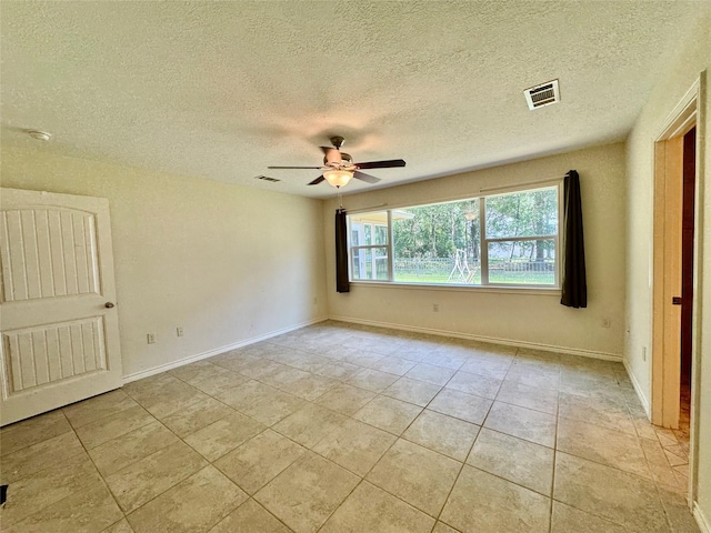 86 Huntington, Trinity, TX 75862 - unfurnished room with ceiling fan, a textured ceiling, light tile patterned floors, and baseboards