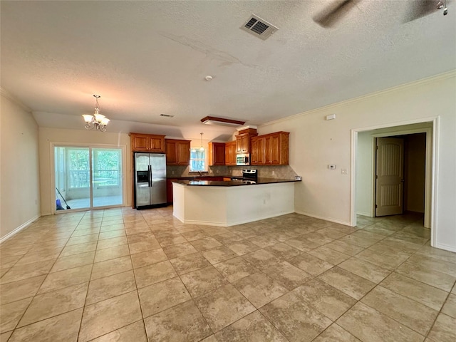 86 Huntington, Trinity, TX 75862 - kitchen with stainless steel appliances, plenty of natural light, a textured ceiling, dark countertops, and a chandelier