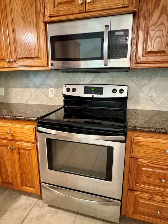 86 Huntington, Trinity, TX 75862 - kitchen with appliances with stainless steel finishes and brown cabinetry
