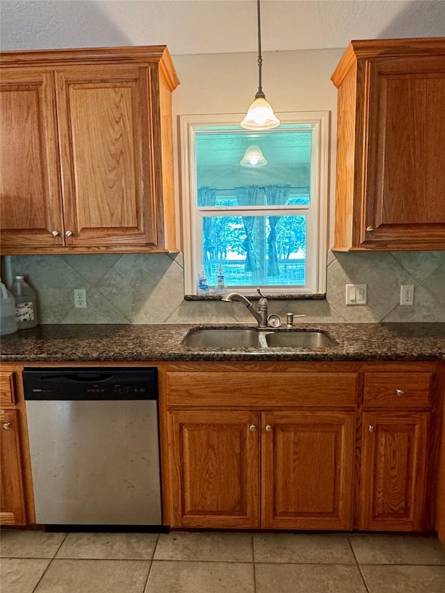 86 Huntington, Trinity, TX 75862 - kitchen featuring dishwasher, a sink, brown cabinetry, and tasteful backsplash