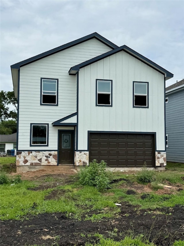 402 N 4th St, Beasley, TX 77417 - view of front facade with a garage, stone siding, and board and batten siding