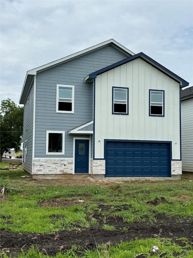 402 N 4th St, Beasley, TX 77417 - view of front of home with a garage, board and batten siding, and stone siding