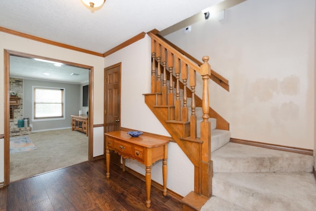 12210 Rocky Lake Ct, Houston, TX 77070 - stairway with crown molding, wood-type flooring, baseboards, carpet, and a fireplace