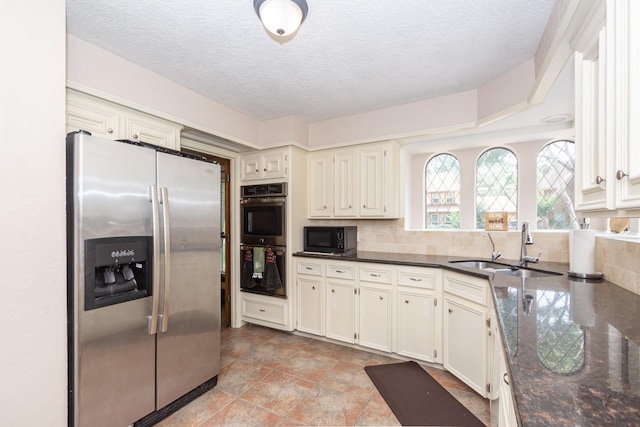 12210 Rocky Lake Ct, Houston, TX 77070 - kitchen featuring stainless steel appliances, a sink, decorative backsplash, a textured ceiling, and dark stone countertops