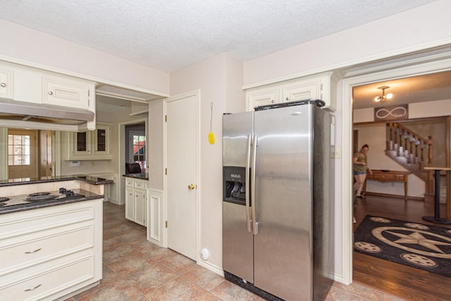 12210 Rocky Lake Ct, Houston, TX 77070 - kitchen with stainless steel fridge with ice dispenser, electric cooktop, dark countertops, a textured ceiling, and white cabinets