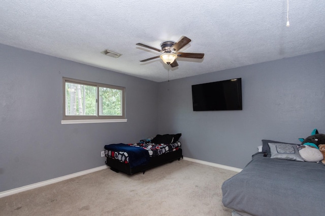 12210 Rocky Lake Ct, Houston, TX 77070 - carpeted bedroom with baseboards, a textured ceiling, and a ceiling fan