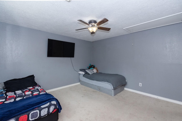 12210 Rocky Lake Ct, Houston, TX 77070 - carpeted bedroom with attic access, a textured ceiling, baseboards, and ceiling fan
