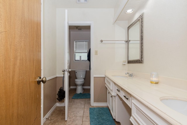12210 Rocky Lake Ct, Houston, TX 77070 - bathroom featuring double vanity, toilet, tile patterned floors, and baseboards