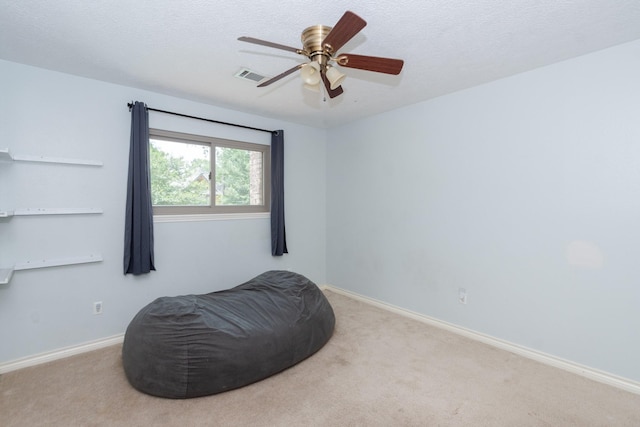 12210 Rocky Lake Ct, Houston, TX 77070 - living area with carpet flooring, baseboards, a ceiling fan, and a textured ceiling