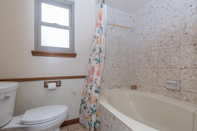 12210 Rocky Lake Ct, Houston, TX 77070 - bathroom with toilet, tiled shower / bath, tile patterned floors, and a textured wall