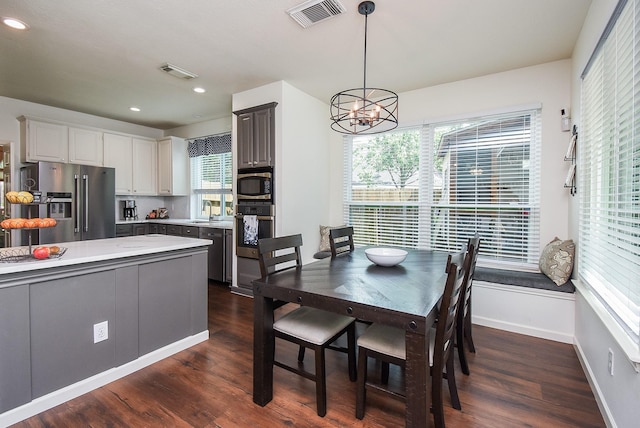 9611 Haven Crossing Ct, Houston, TX 77065 - dining area featuring a chandelier, dark wood-style flooring, baseboards, and recessed lighting