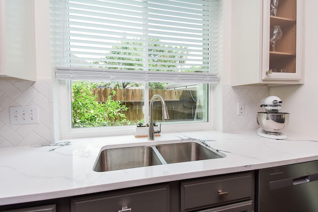9611 Haven Crossing Ct, Houston, TX 77065 - kitchen featuring a sink, dishwasher, glass insert cabinets, light stone countertops, and plenty of natural light
